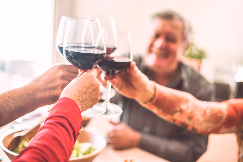 Senior friends cheering with red wine glasses at restaurant lunch shutterstock_1296442588 840