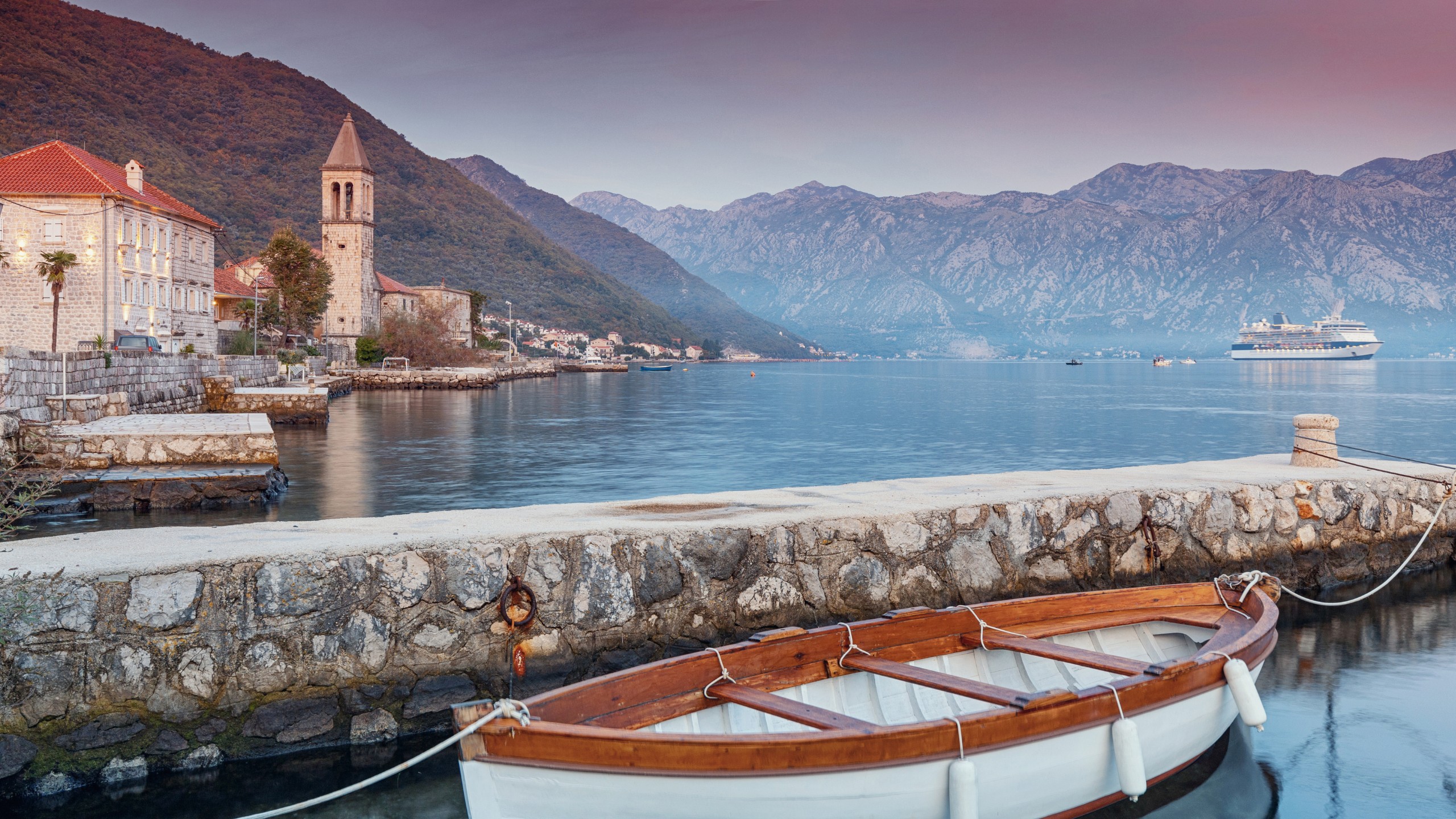 Wooden boat moored at the dock in coastal village Donji Stoliv, Montenegro, a scene to enjoy on our vacation.